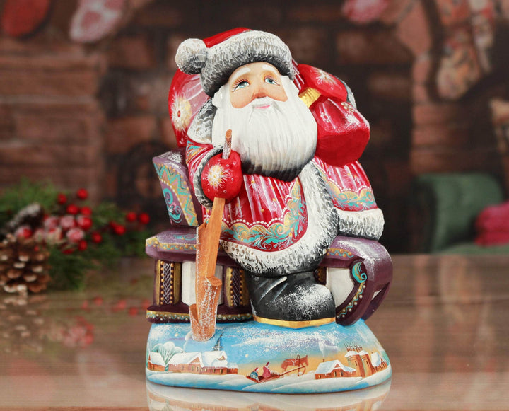 Santa figurines red and blue Santa Claus on a sled